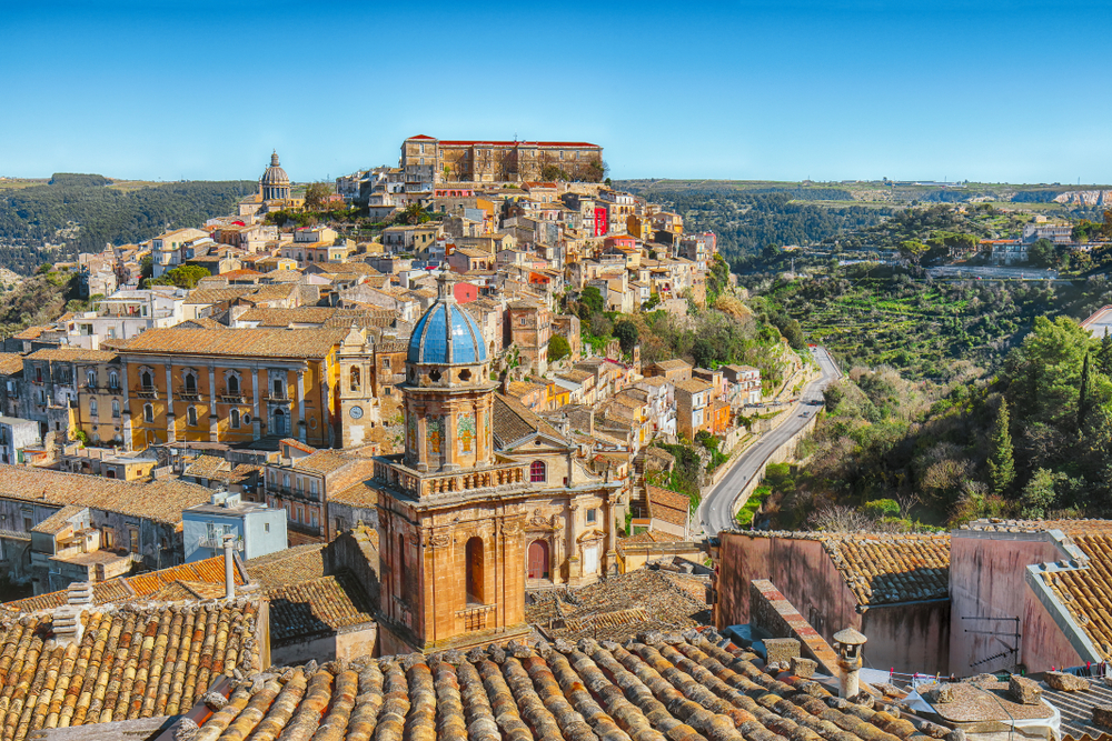 Mid-afternoon photo of the old baroque town of Ragusa, one of the best places to visit in Sicily, with its streets winding through old buildings