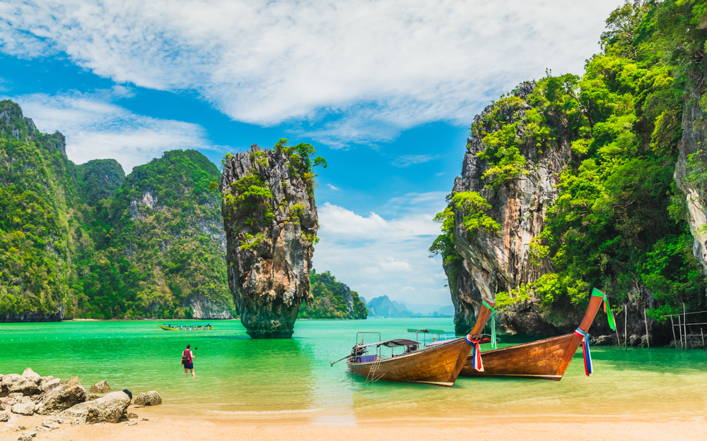 Stunning view of the rock formation in Phuket, one of the best places to visit in January, with boats on the water