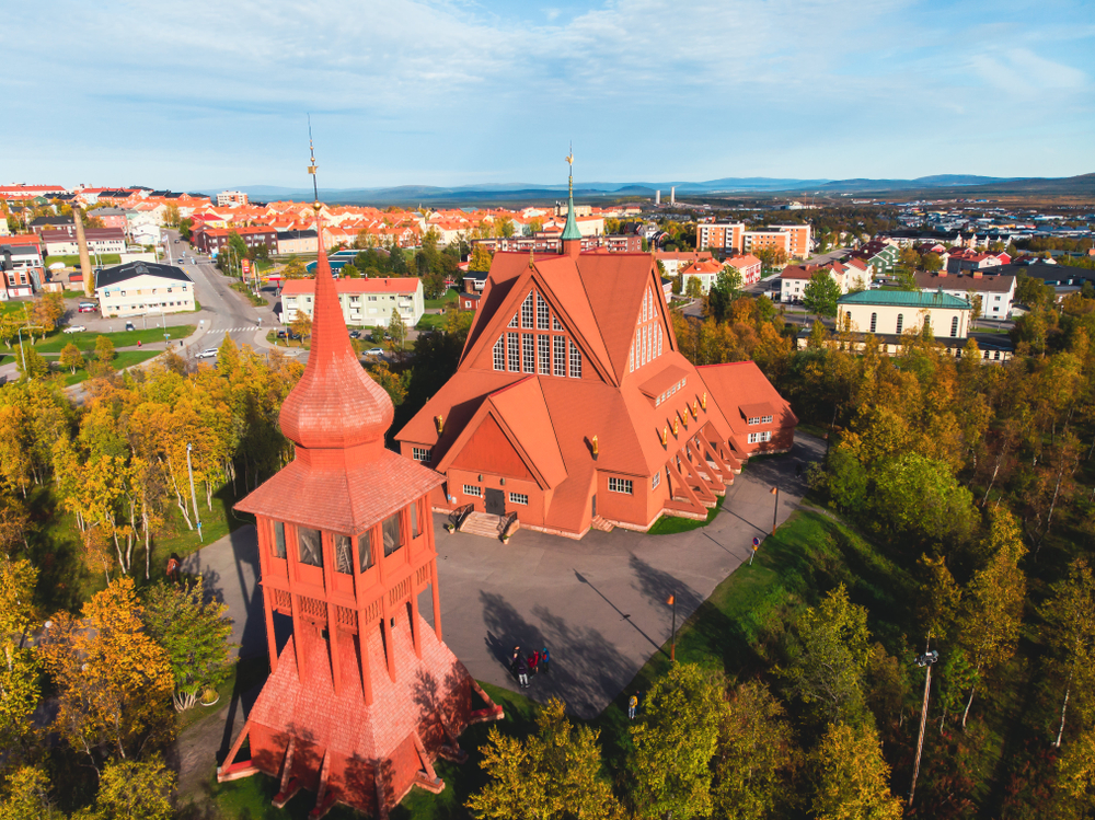 Old red church and lookout tower in Kiruna, one of the best places to see in Sweden