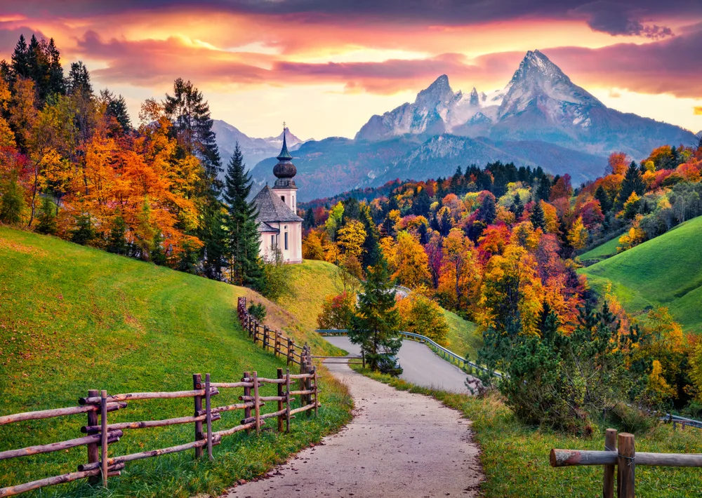 Picturesque view of Bavaria in Germany, one of the best places to visit in October, pictured with Maria Gern Church with Hochkalter Peak in the background
