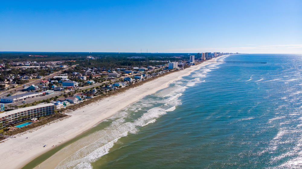 Aerial view of the expansive stretch of beach in Gulf Shores, pictured during the best time to visit
