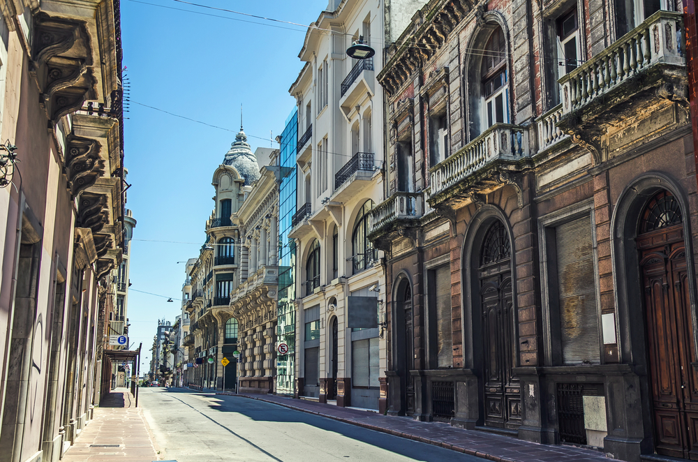 Neat view of historical old buildings lining a street with nobody on it in Uruguay, one of the best places to visit in July