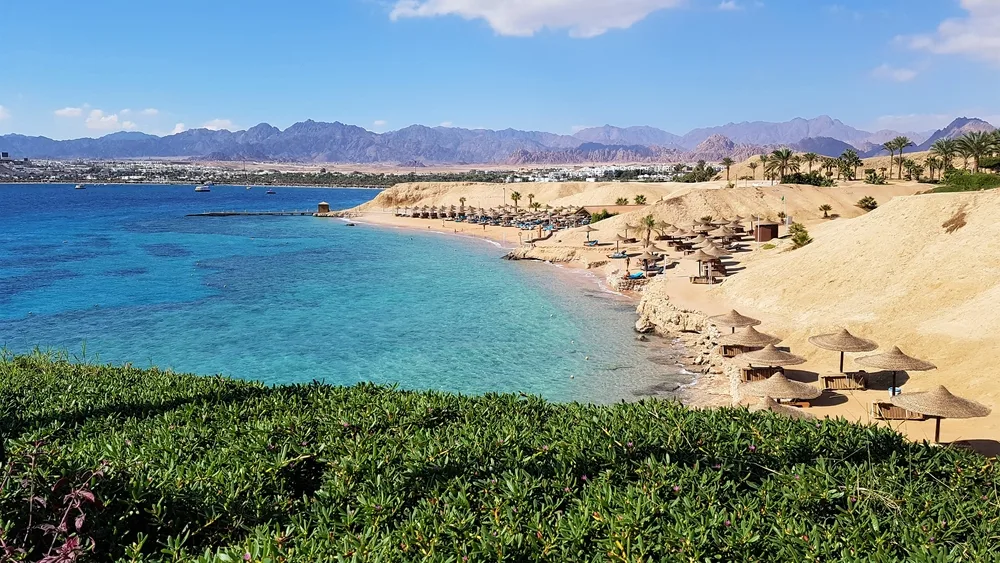 Hotel Beach on Naama Bay in Sharm El Sheikh in Egypt shows one of the best beaches in Africa with mountains in the distance