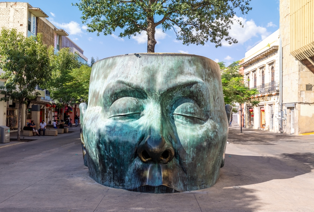 Photo of a head sculpture with a tree growing out of it in Guadalajara