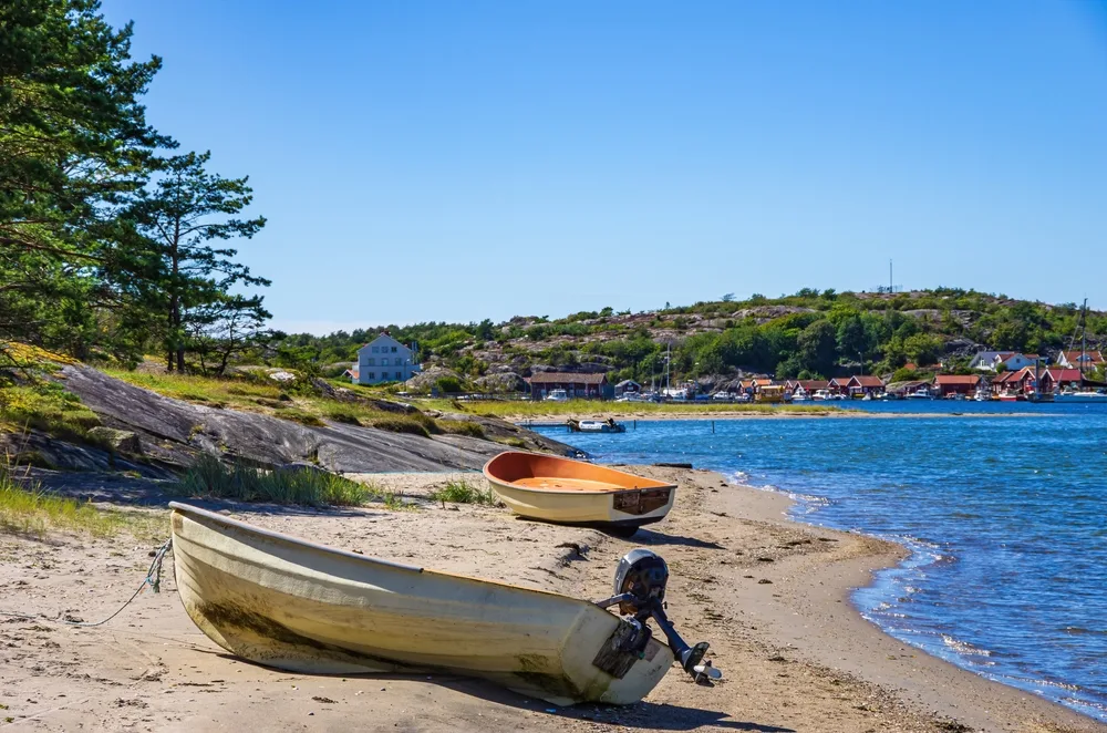 Two old motorized fishing boats pictured beached on the coast of Kosterhavet, one of the best places to visit in Sweden