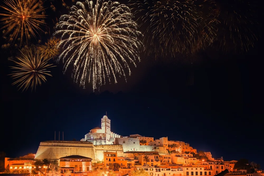 Fireworks over Ibiza pictured in the nighttime on New Year's Eve, pictured as one of the best places to visit in the world in December