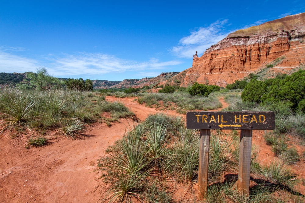 Palo Duro Canyon pictured with a sign that points to the trailhead