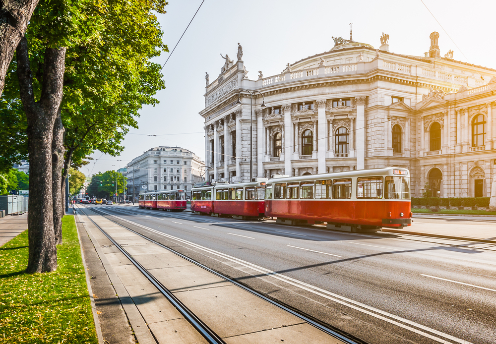 Early afternoon view of the famous Wiener Ringstrasse theatre and the electric tram on an otherwise empty-street day to help answer whether or not Austria is safe to visit