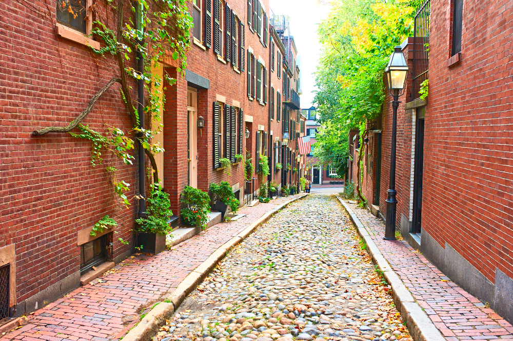 Historic Acorn Street seen with leaves falling and on the ground in October in Boston