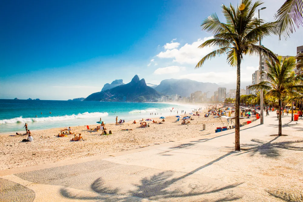 For a piece titled Is Brazil Safe to Visit, a photo of the gorgeous Rio de Janeiro beach with Two Brothers Mountain in the background