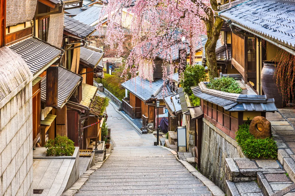 Amazing street view of Kyoto pictured during the least busy time to visit with empty stone walkways between old wooden homes