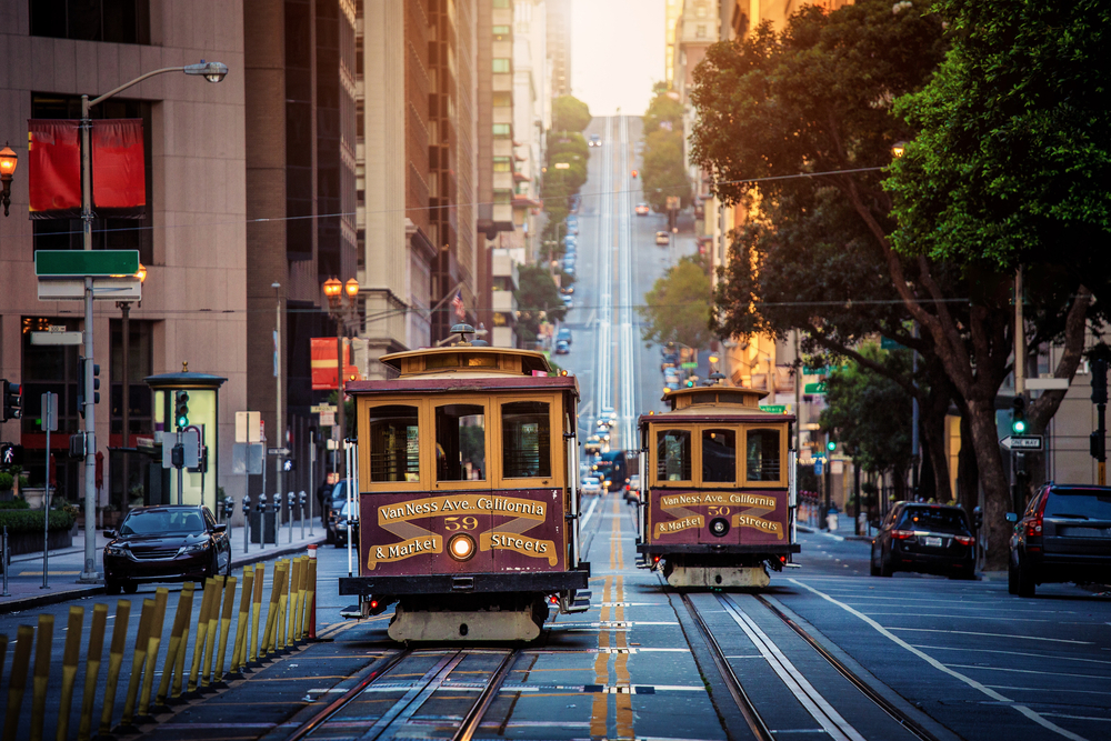 View of classic cable cars making their way up the steep streets of San Francisco, one of the least expensive places to fly in the US