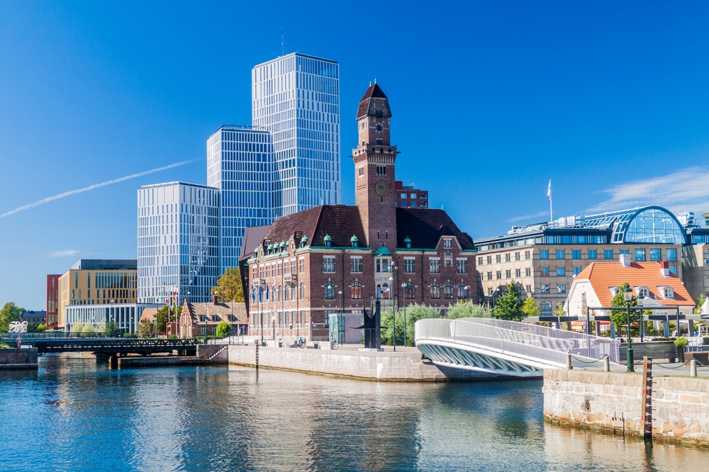 Old courthouse and modern skyline in Malmo, one of the best places to visit in Sweden, as seen from a boat looking toward the shoreline