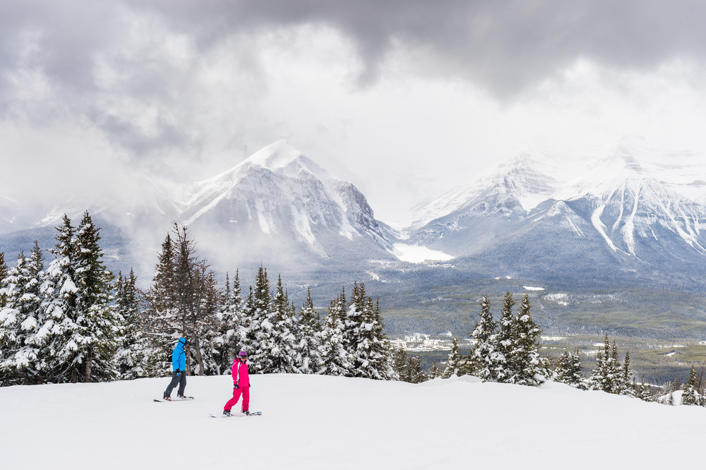 Two people snowboarding in the ski area of Lake Louise