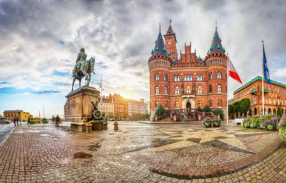 The Helsingborg Town Hall, as seen from the perspective of a person walking on the brick path, on a cloudy day in Sweden