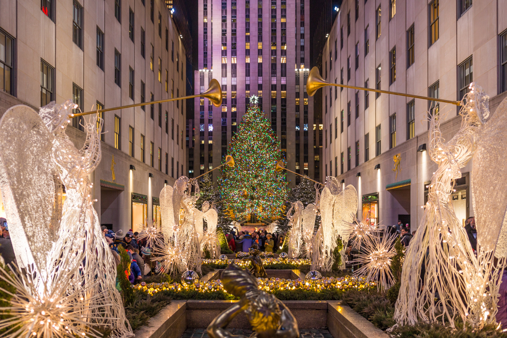Angels below the light-up Christmas tree in Rockefeller Center pictured as one of the best places to visit in December