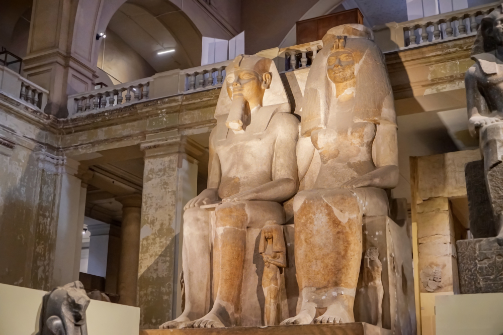 Giant statues of Amenhotep III in the Museum of Egyptian Antiquities pictured for a piece titled Is Cairo Safe to Travel to