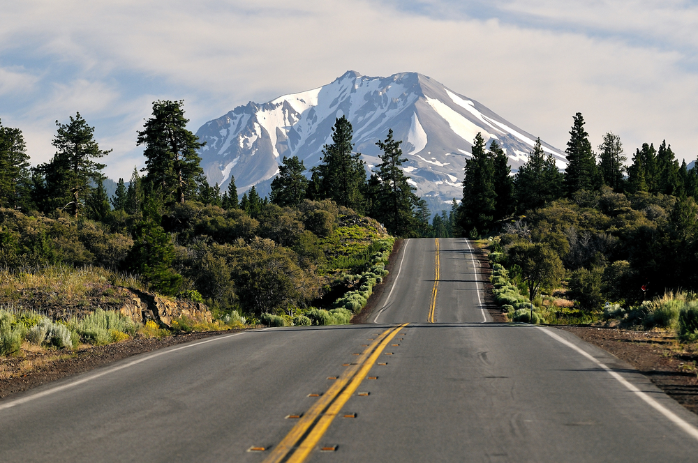 Hilly road leading toward the giant mountain by Mount Shasta pictured during the overall worst time to visit Mount Shasta, the spring