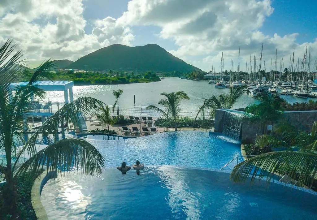 As one of the featured all-inclusive resorts in St. Lucia, a photo of the pool and beach area at the Harbor Club St. Lucia