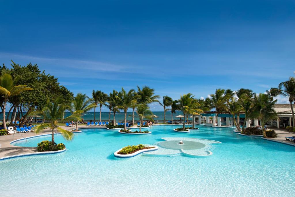 Breathtaking view of the expansive pool at one of the best all-inclusive resorts in St. Lucia, the Coconut Bay Beach Resort and Spa