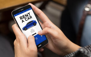 Smartphone showing concept of rental car app for a piece answering how much is a rental car