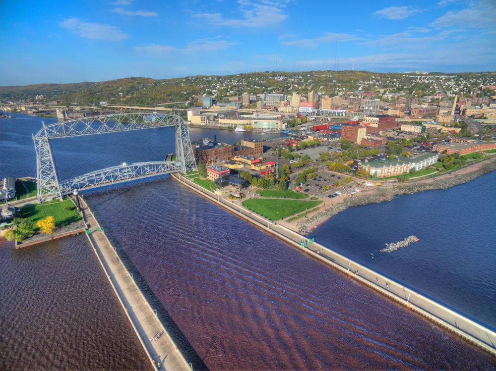 Aerial view of the long causeway and giant metal bridge in Duluth, a popular place for tourists to visit in Minnesota