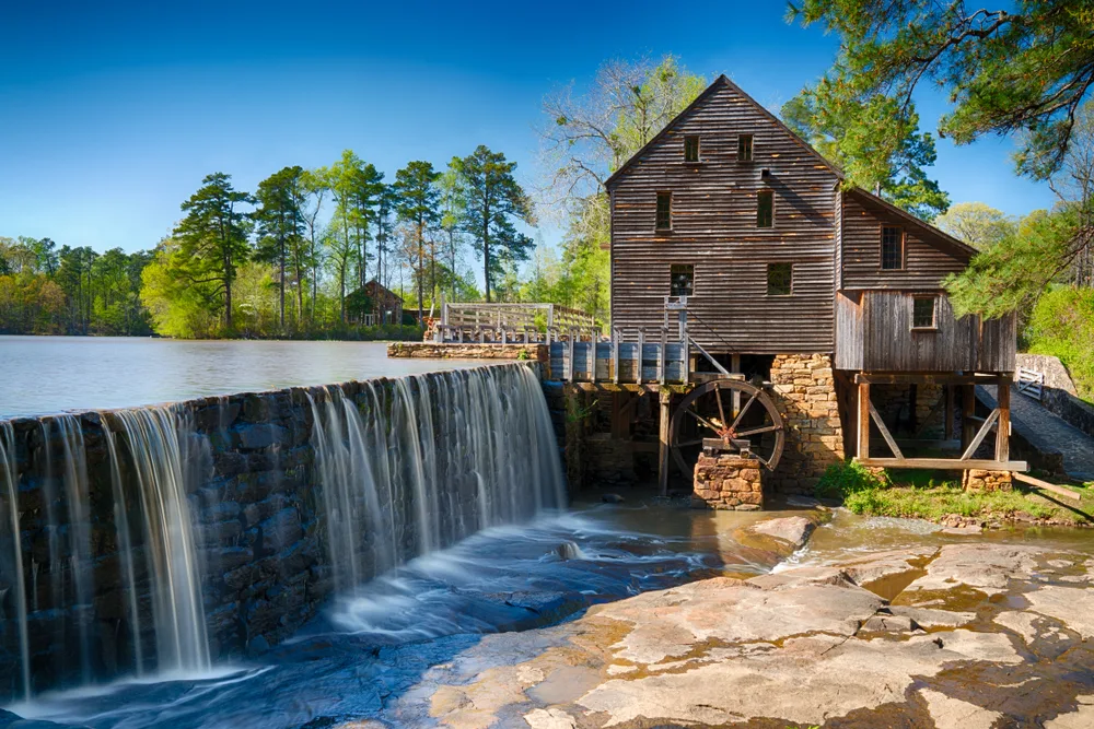 Unique wooden structure next to a waterfall and water mill in Raleigh