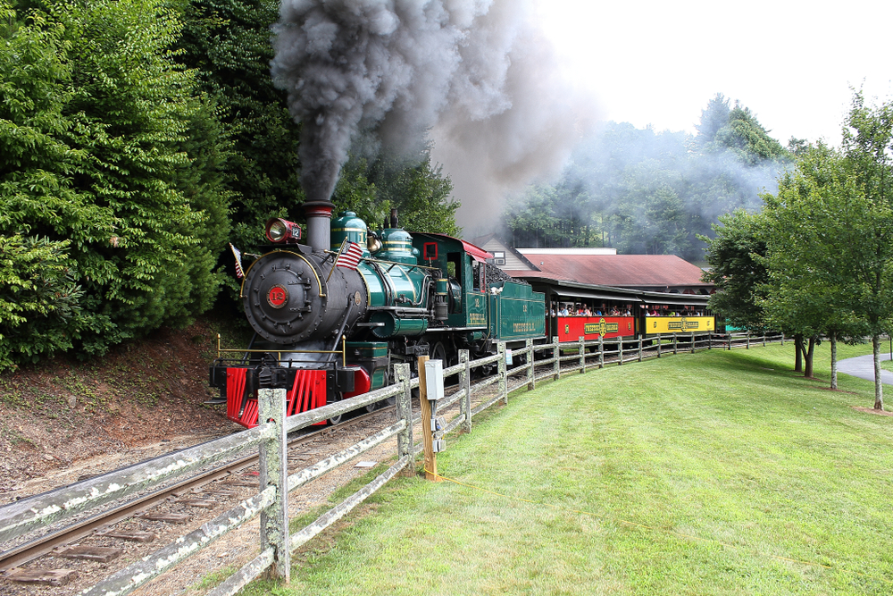 Steam train making its way down the tracks of a well-manicured park in Boone, North Carolina, a top attraction in the state