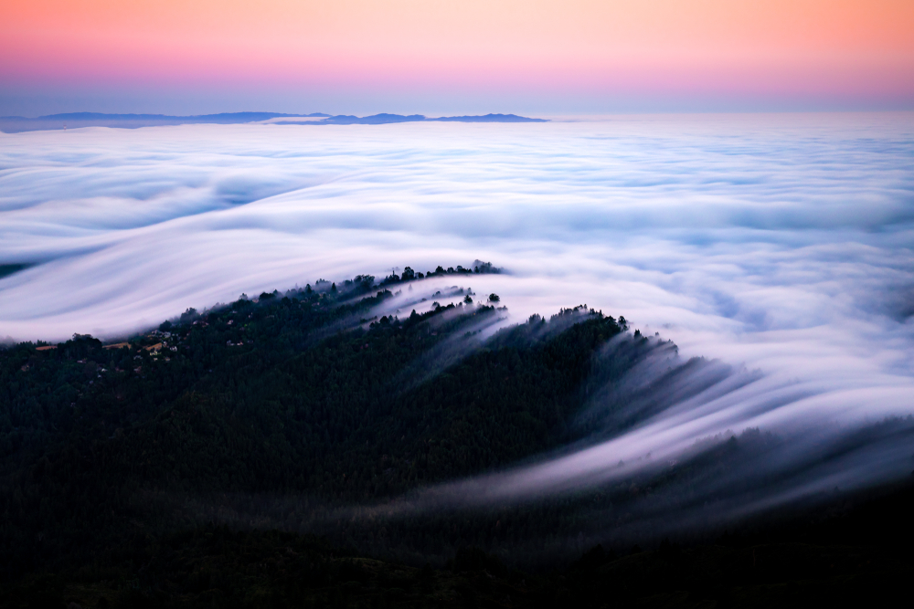 Fog and clouds pouring over the hills on Mount Tam, one of the best places to visit in the Bay Area