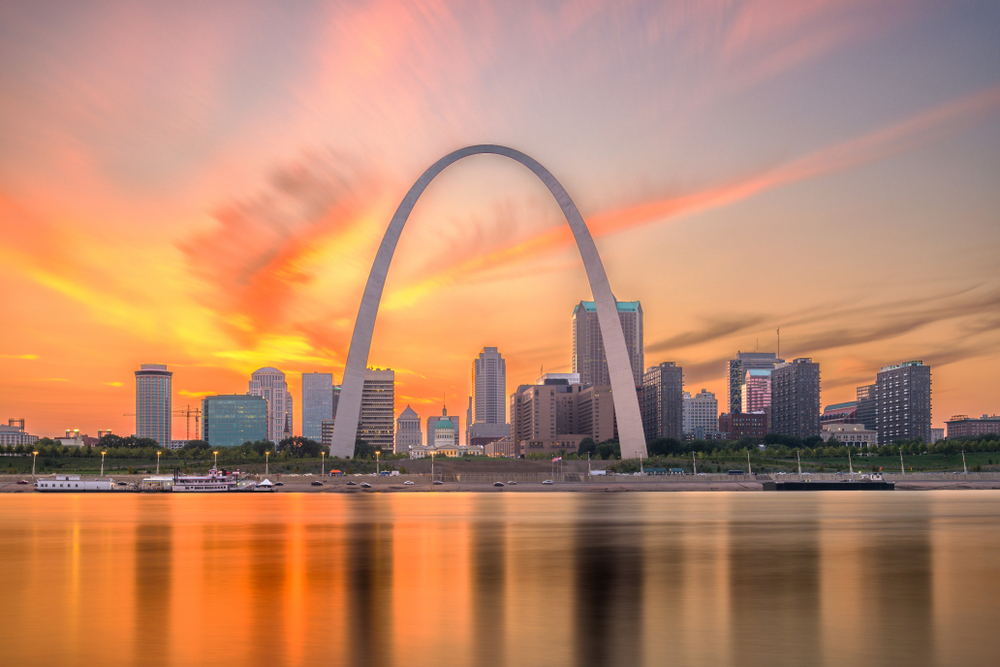 The Arch in St. Louis pictured at dusk from across the river for a piece on the best places to visit in the Midwest