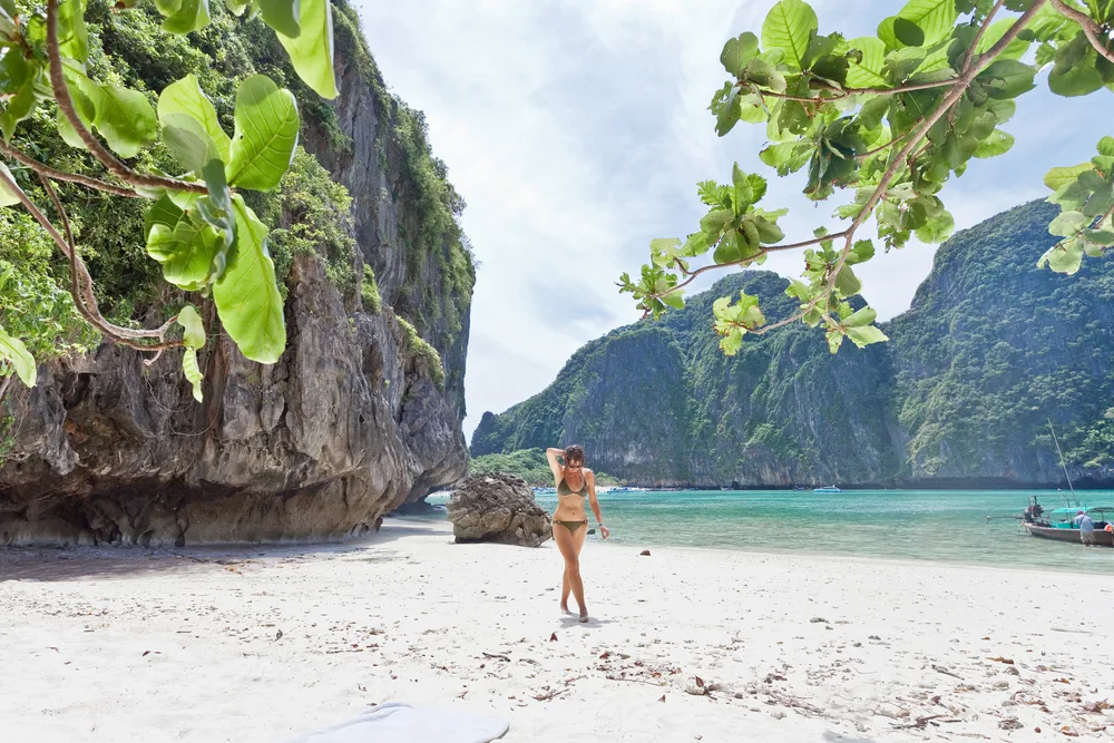 Attractive and tall woman in a bikini on a beach in Ko Phi Phi, a top pick for the best places to visit in Thailand