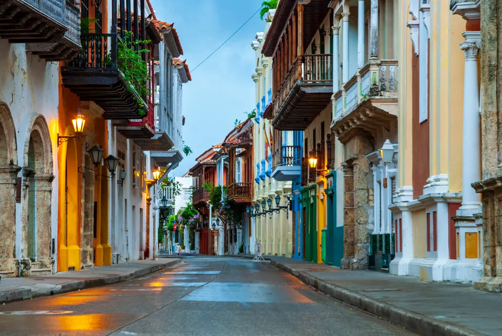Old buildings on either side of a narrow walking path in Cartagena, one of our top picks for the best places to visit in Colombia