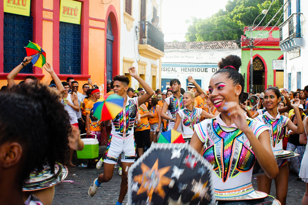 Gorgeous Brazilian people in colorful outfits walking through the streets of Olinda