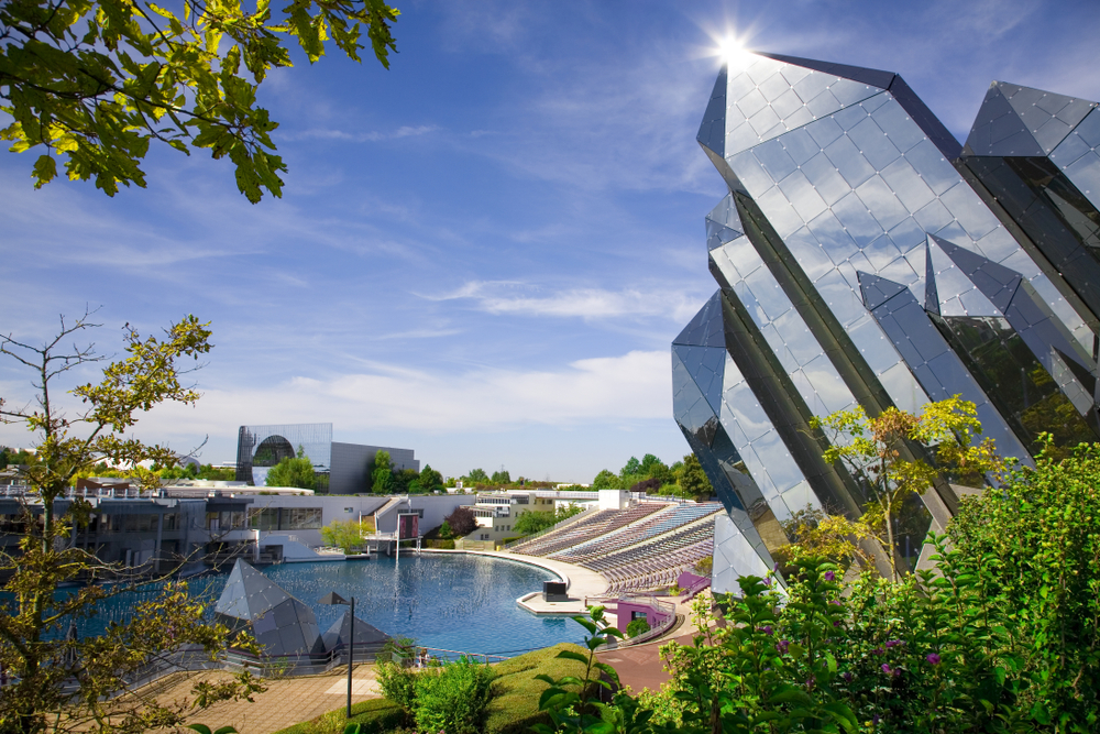 Futuroscope, a unique day trip from Paris, with its amazing mirrored buildings jutting into the air in front of a blue sky