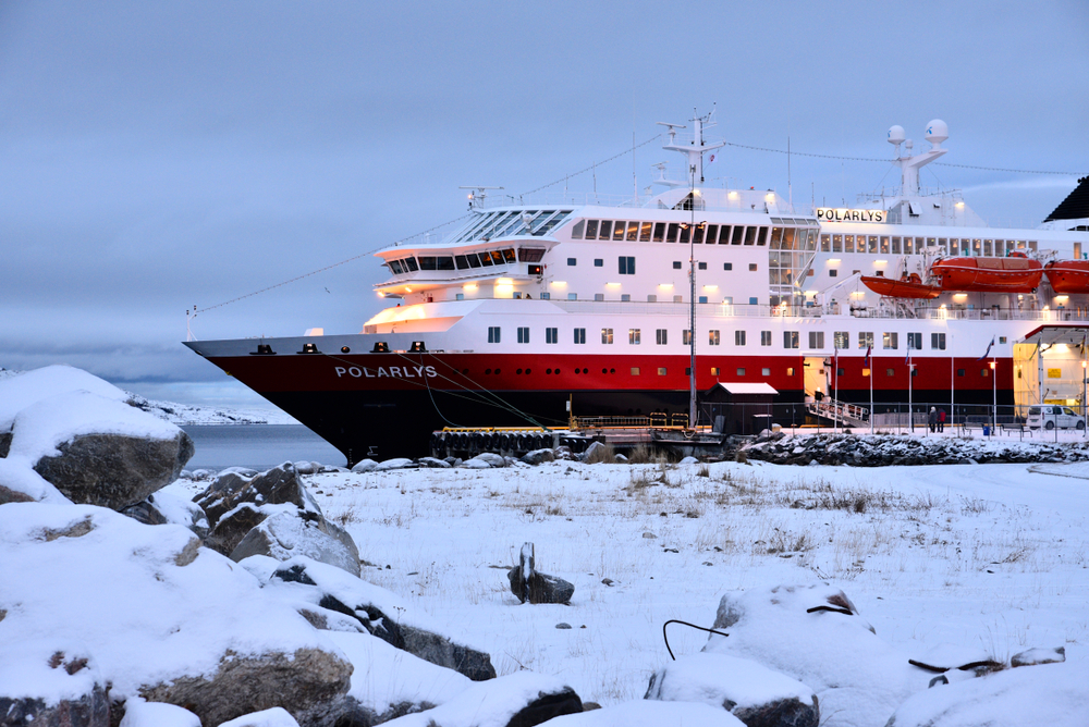Small coastal town in Norway called Kirkenes with its red and black ferry docked at its port