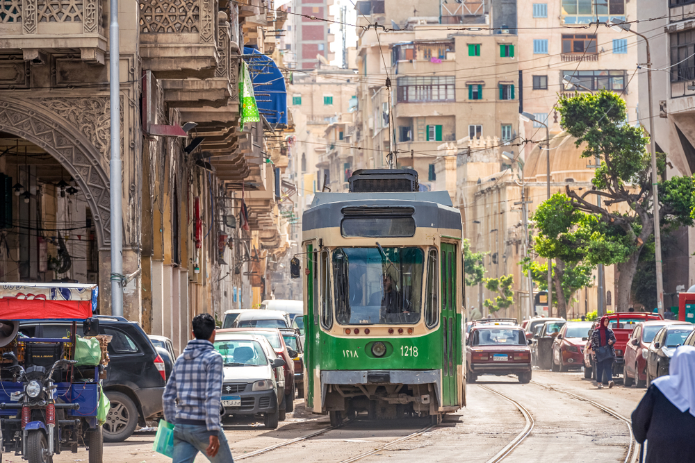 Green tram making its way down the tracks in Alexandria in Egypt