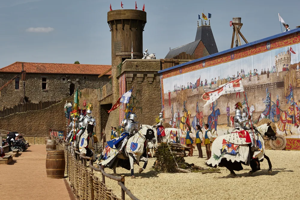 Puy Du Fou, a great day trip from Paris, pictured with knights and castles in full view of the spectators sitting in the stands