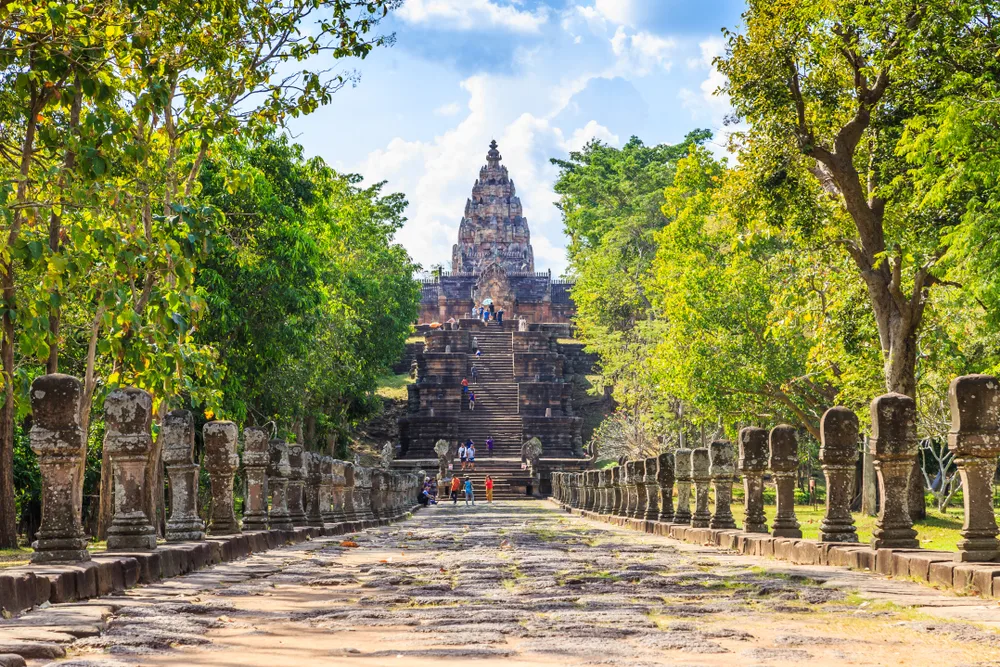 Phanom Rung temple and a long stone path leading to the temple pictured as a featured must-visit place in Thailand
