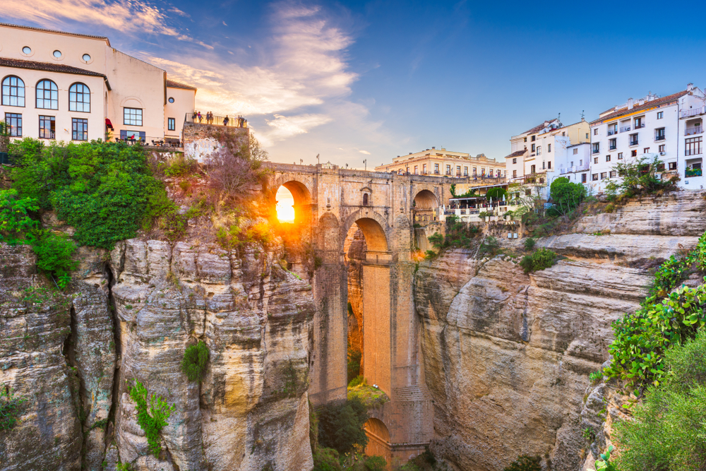 Breathtaking view of the town of Ronda in Spain, built on a giant rock, with a tall bridge connecting the two parts