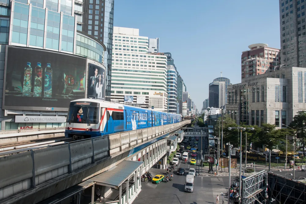 Skytrain drives by a number of tall buildings in the Sukhumvit district, one of the best places to stay in Bangkok