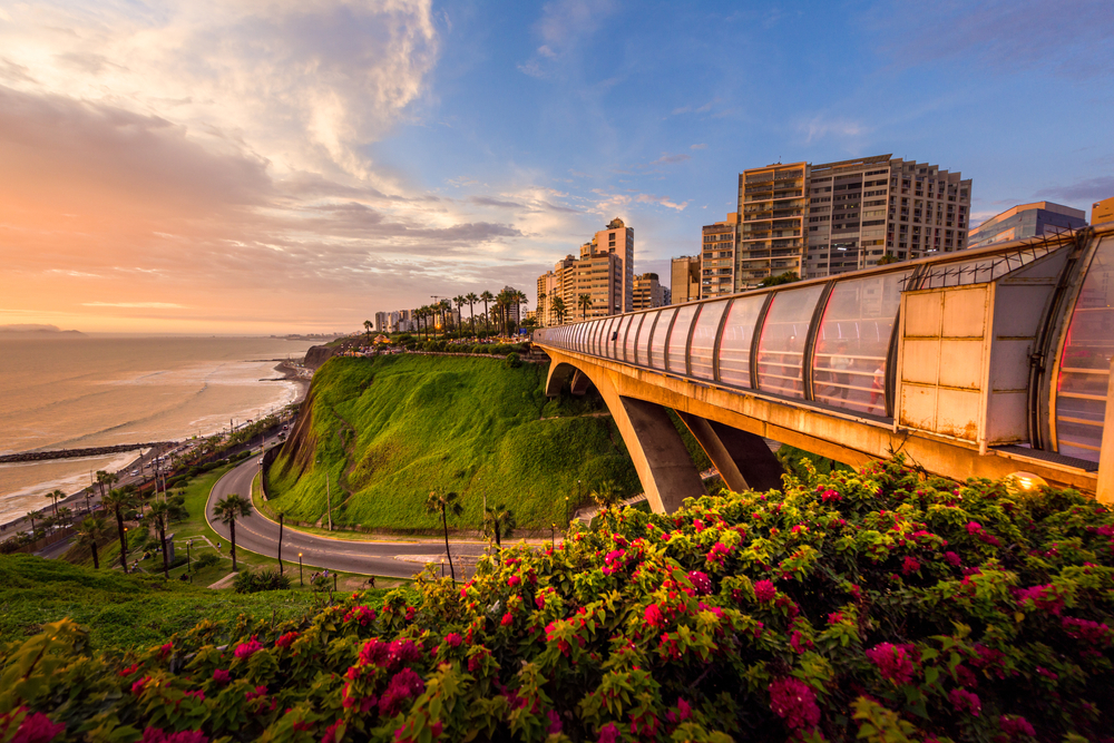 Very neat shot of the rusty Villena Bridge in Miraflores spanning the road that leads to the ocean in a breathtaking image, seen at dusk