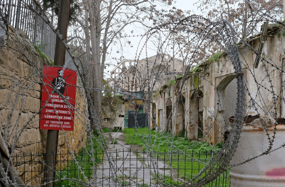 Photo of the Green Line in Cyprus pictured with barbed wire on the outside of the compound