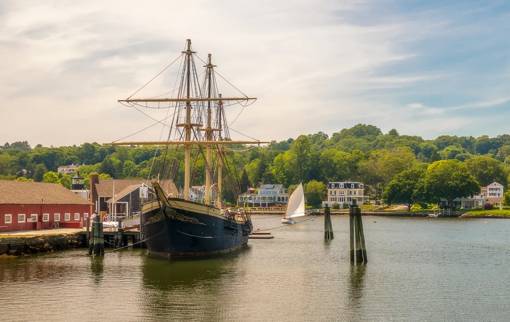Mystic Connecticut pictured from the pier looking out toward the bay with a giant sailing ship on the water