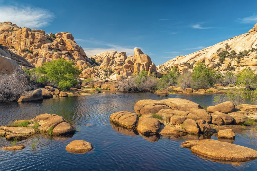 Lake and unique rock formations surrounding the water in one of the best places to visit in Southern California, Joshua Tree National Park
