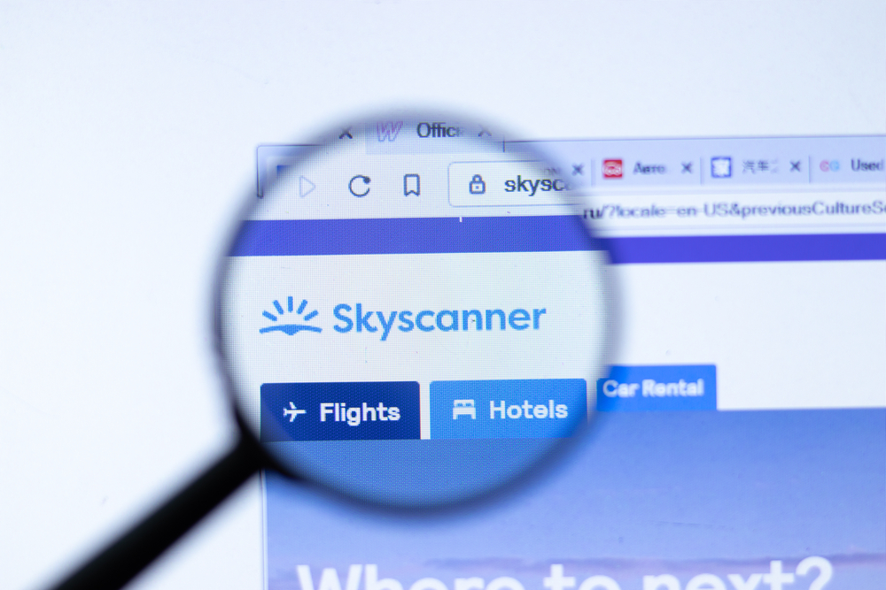 Skyscanner website with magnifying glass over the logo on the website for a piece covering recent Skyscanner reviews 