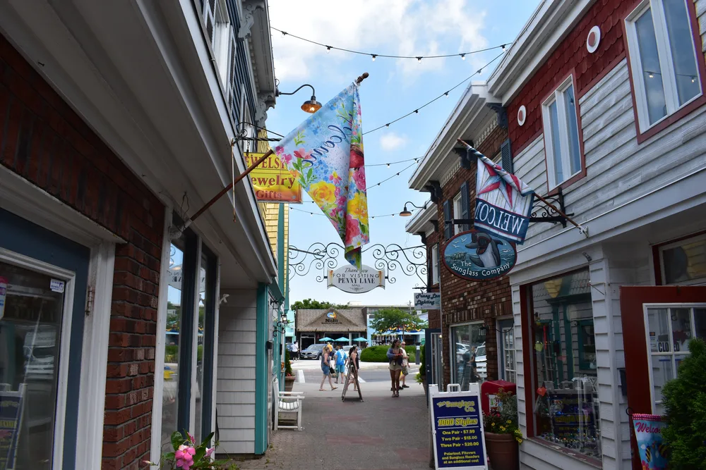 Little shops in Rehoboth Beach, one of Delaware's best places to visit, pictured on a calm day along the boardwalk