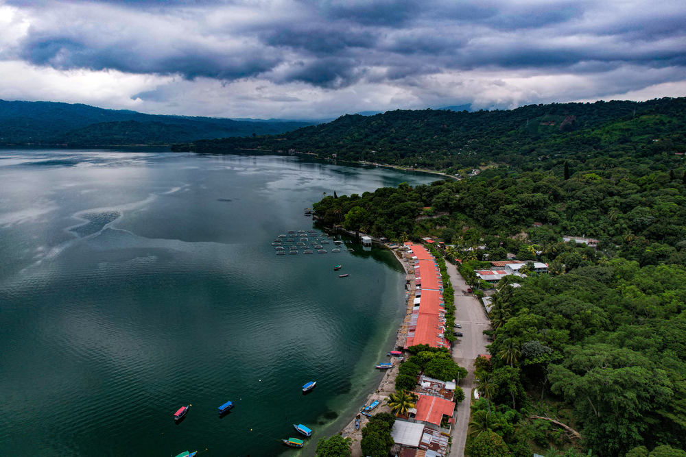 Lake Ilopango in San Salvador pictured from the air on a dark and gloomy day as a featured must-visit place on a trip to El Salvador