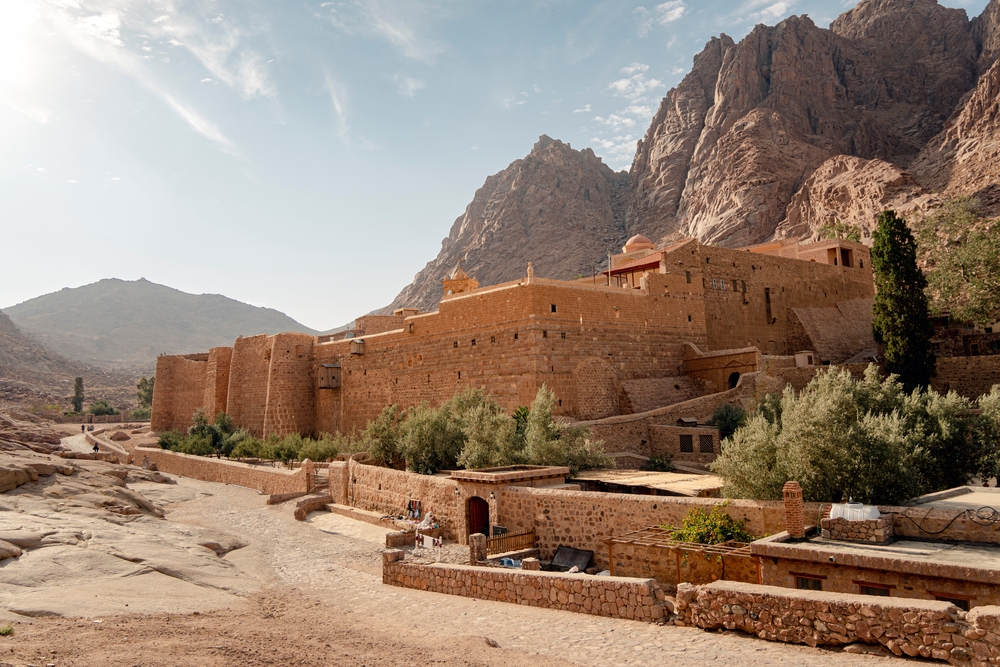 Giant fortress-like St. Catherine's Monastery, one of the best places to visit in Egypt, as seen from the walking path outside the city walls