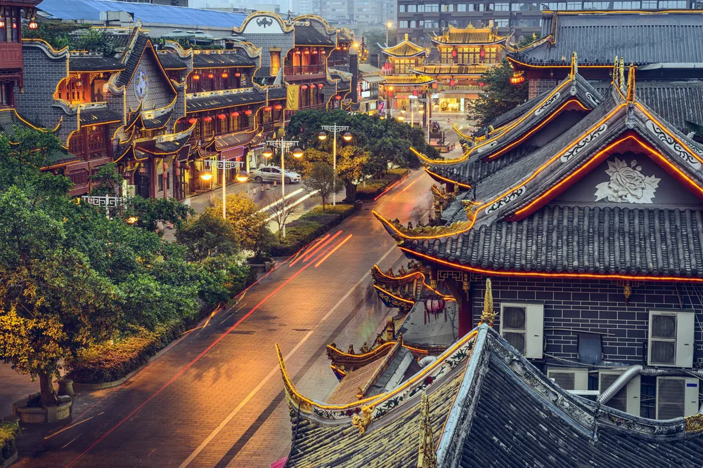 Unique night scene in the town of Chengdu, a traditional Chinese village and also one of our top picks for must-visit places to see in China, as seen from the top of a classically-styled building