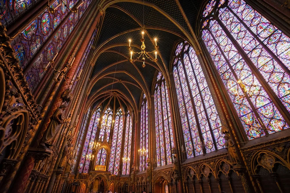 Stained glass windows of Sainte-Chapelle, one of the beset places to visit in Paris, pictured from the ground floor looking upward